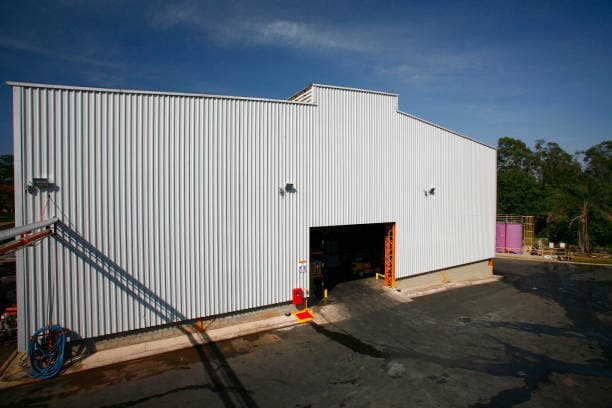 Large white metal industrial building with loading bay