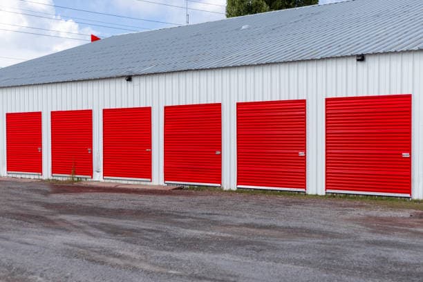 Metal building with multiple red roll-up doors