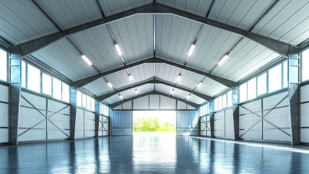 Interior of a clear-span metal building with overhead lights