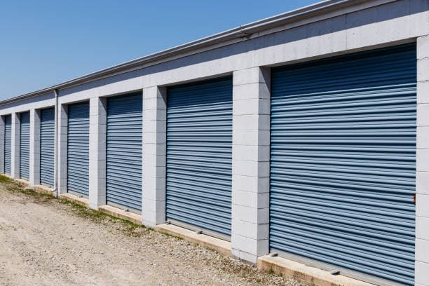 Commercial storage building with blue roll-up doors